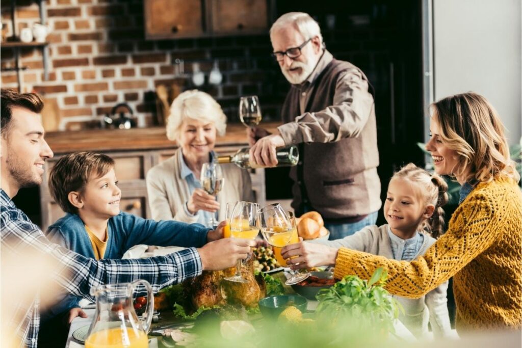 Family at the holiday table learning How to Manage Arthritis During The Holidays.