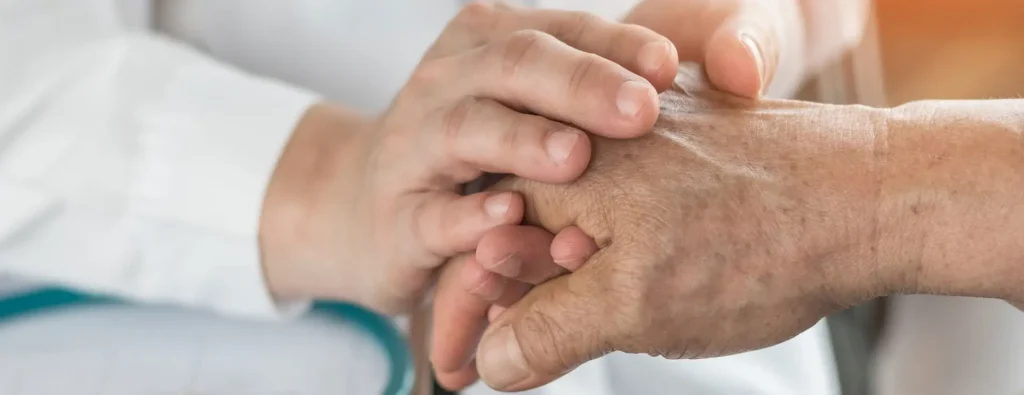 Close-up of caring hands clasped together to represent arthritis support; highlighting that arthritis affects over 50 million adults in the U.S.